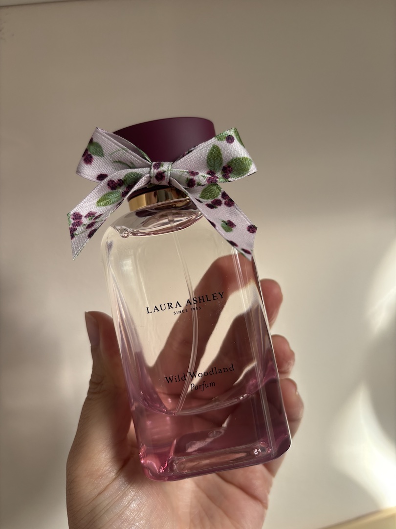Mica Ricketts holding bottle of Laura Ashley Wild Woodland