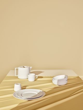 White plate and mugs on a wooden table