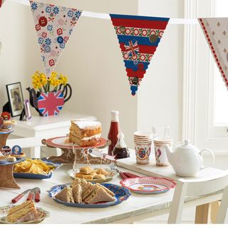 room with bunding flag and food on table