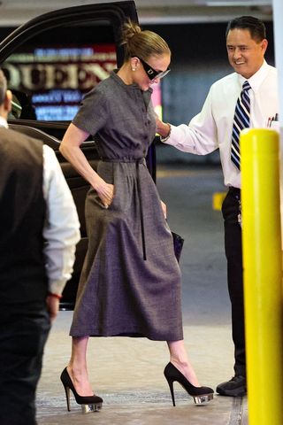 Jennifer Lopez wearing a chic gray shirt dress with platform heels while in Los Angeles May 2024