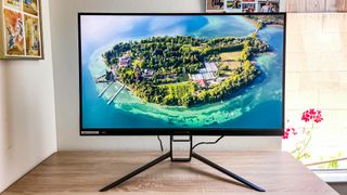 Acer Predator XB323QK gaming monitor w/ 4k video onscreen showing island off the coast of italy