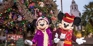 Mickey and Minnie Characters in front of Christmas tree