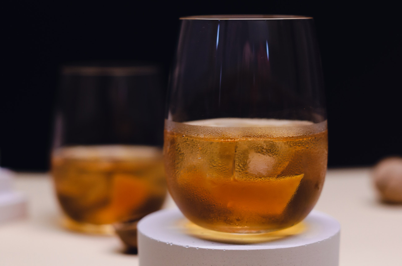 Two glasses with ice and Cognac against a black background