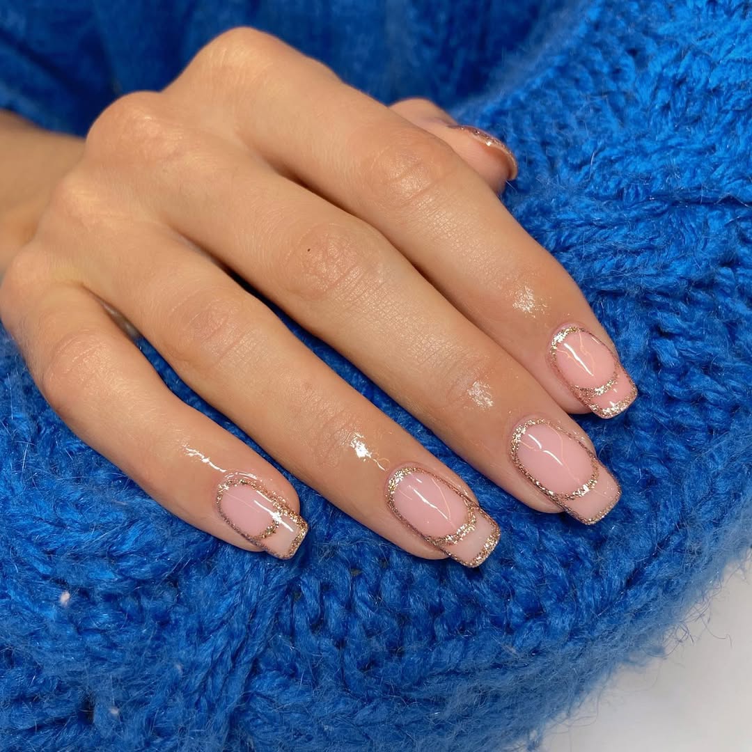 gold glitter and sheer pink manicure