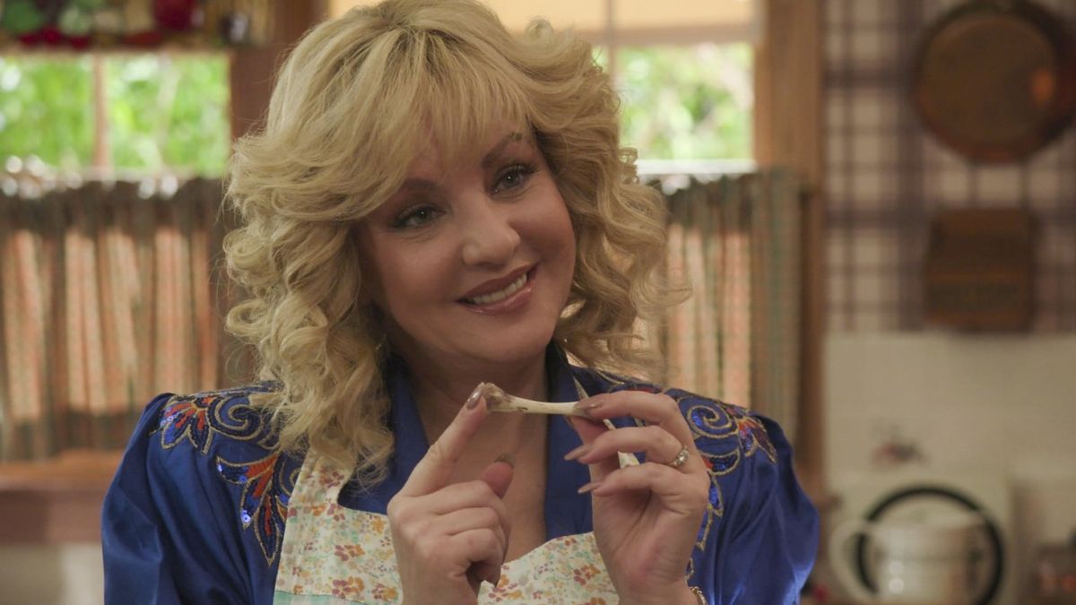 Beverly holding chicken bone in The Goldbergs