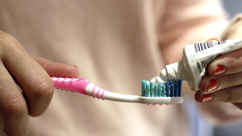 a close-up of toothpaste being applied to a toothbrush