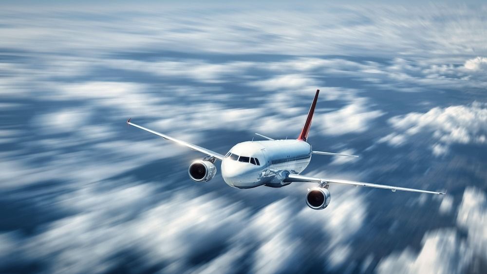 A commercial airliner soaring through the clouds. 