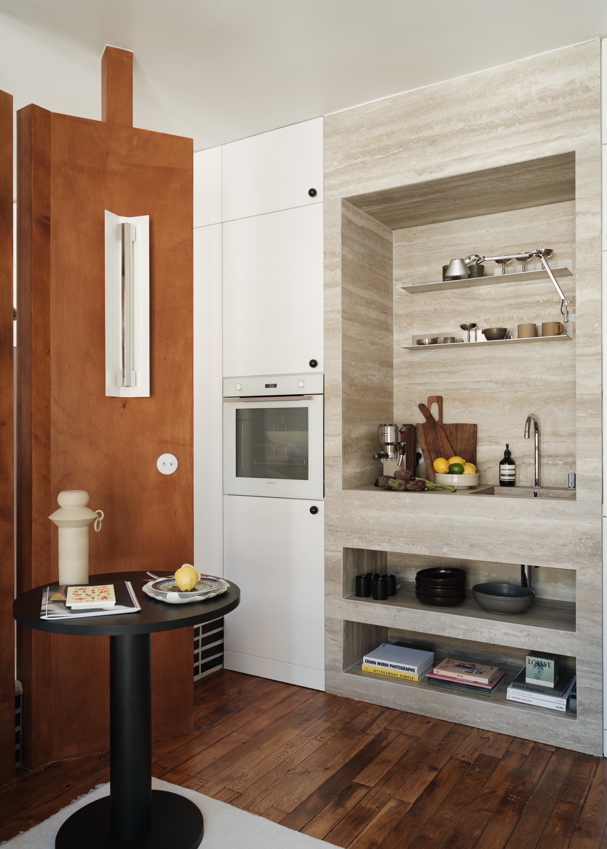 small apartment with a travertine kitchen that has open shelving units as well as a built in kitchen appliance
