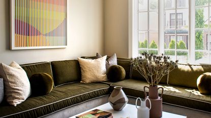 a beige living room with a khaki sofa