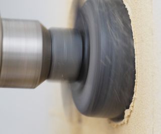 A diamond core drill drilling into a wall