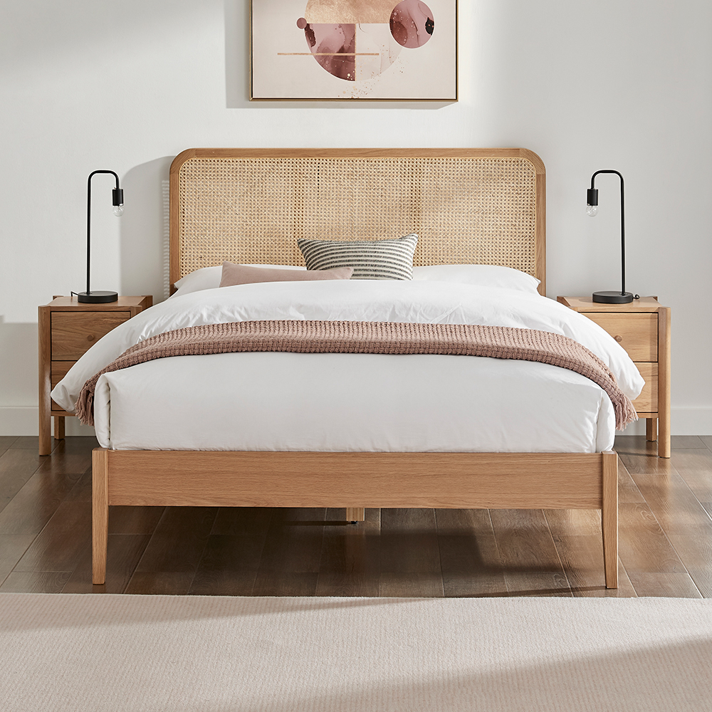 Rattan wooden bed frame in a white bedroom