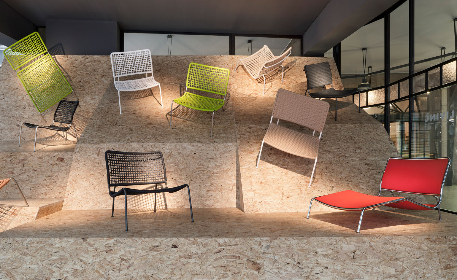 Art work of coloured chairs attached to MDF wavy board