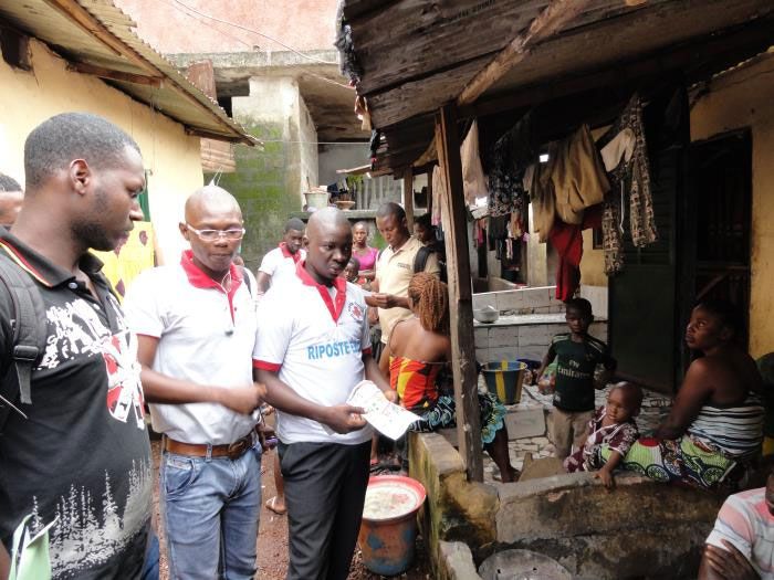 Photo from the 2014 Ebola outbreak in Guinea. Volunteers go door-to-door sharing information about the deadly virus.