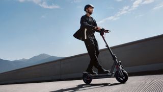 Guy riding a Segway Max G3 on the road.