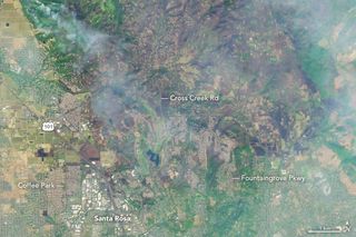 A zoomed-in view from Landsat 8 shows the heavily burned area between Santa Rosa and Calistoga, where wildfires have torched at least 34,000 acres.