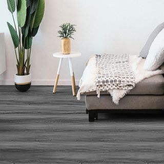 A living room featuring charcoal grey peel and stick flooring.
