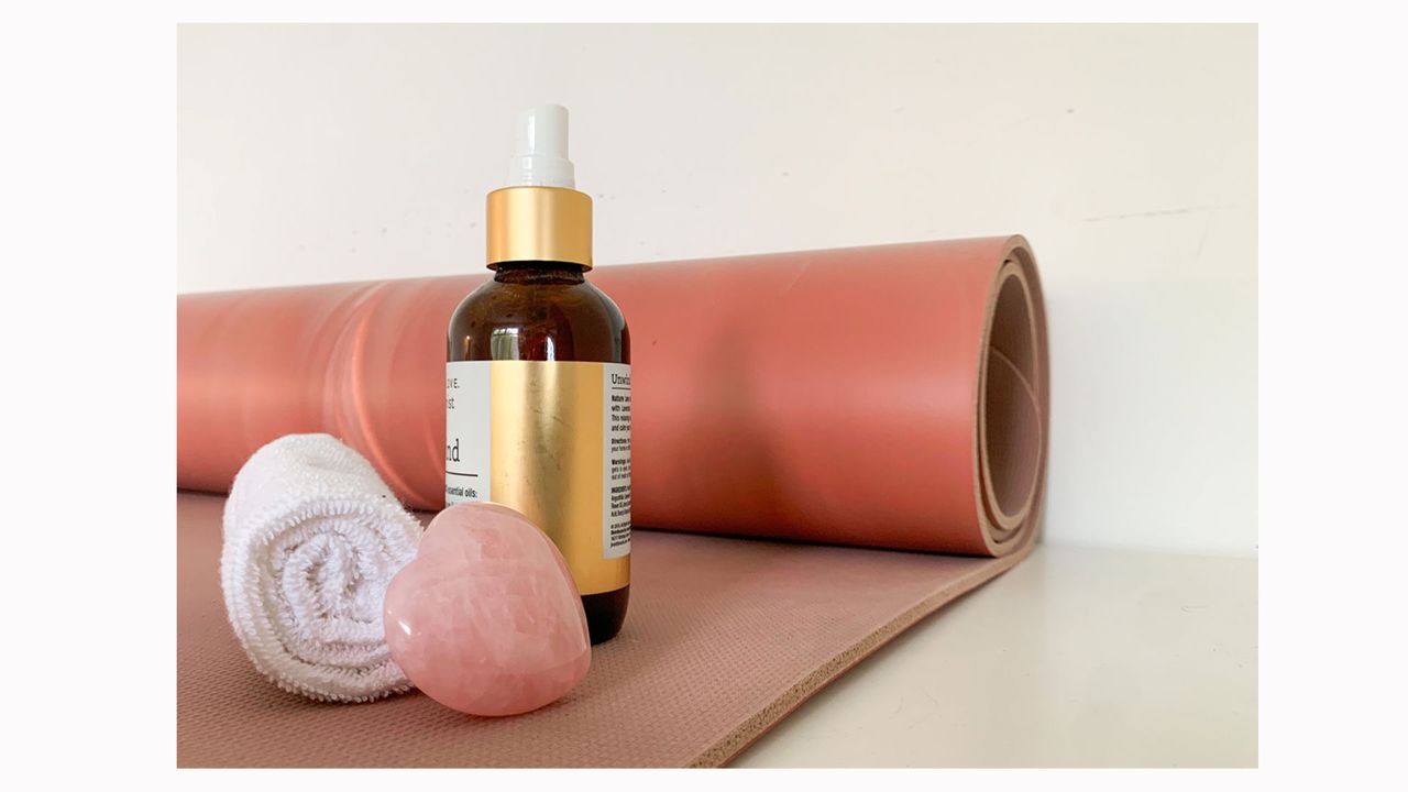 Image shows a pink Lululemon Reversible 5mm Yoga Mat with yoga accessories.