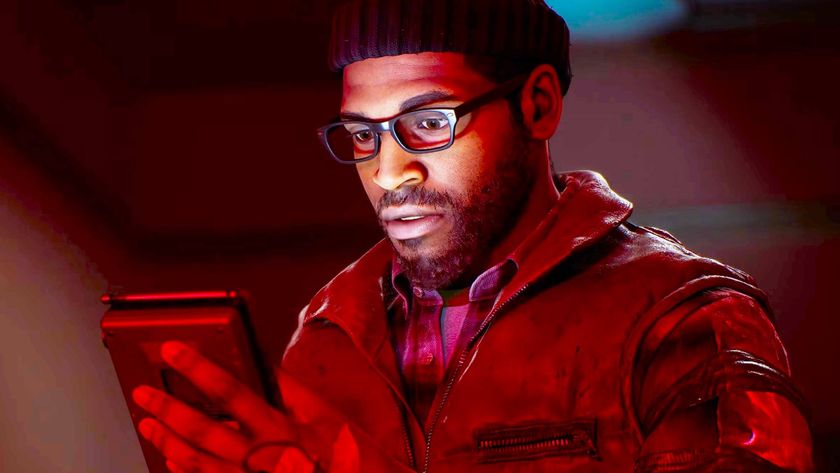 A screencap of the Silent Hill Townfall reveal trailer. A man wearing a beanie and thick glasses peers down at a handheld device. His face is illuminated by the glow of the screen.