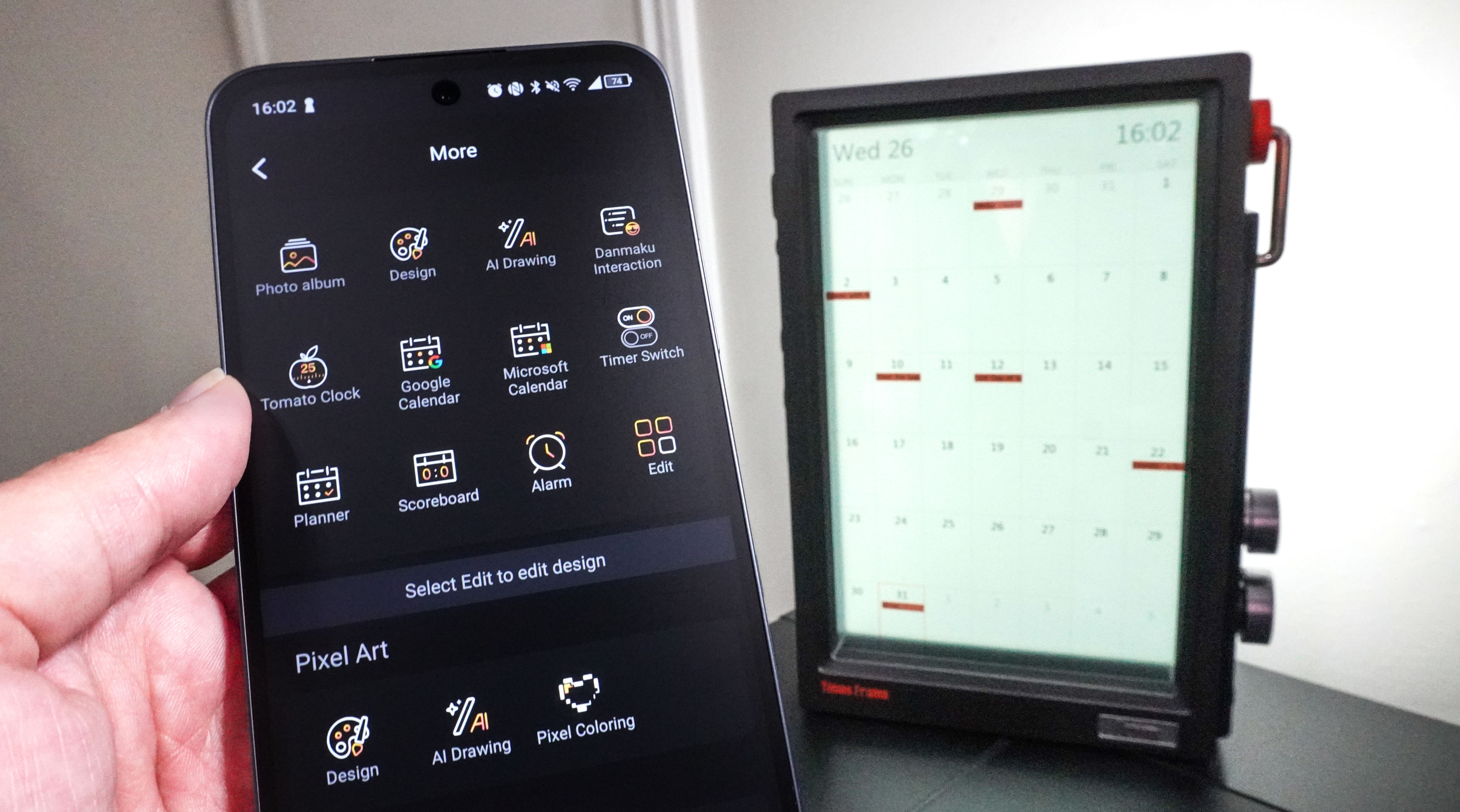 The Divoom Times Frame displaying a calendar in the background with a person holding up a phone showing the calendar integrations in the Divoom app