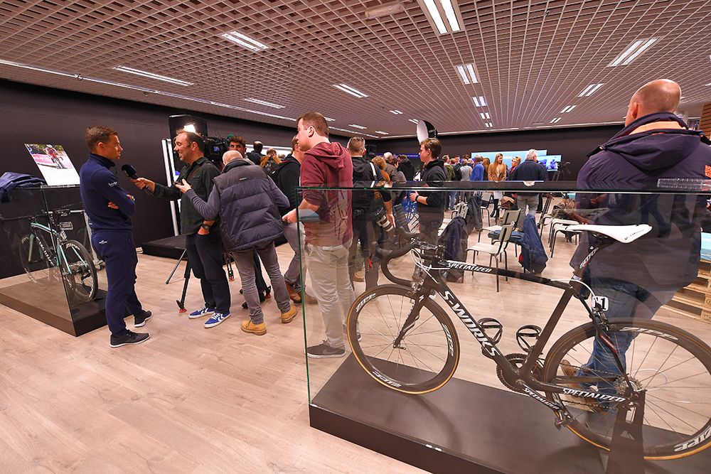Specators and fans mingle during the team press conference at the Quick-Step Floors Pop-Up Store in the Ring Shopping Center in Kortrijk