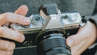 Close up of the OM System OM-3 mirrorless camera's top plate in use