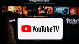 YouTube TV logo on a phone in front of a TV