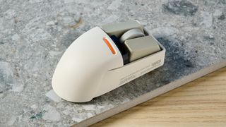 The Lofree Touch mouse on a stone surface