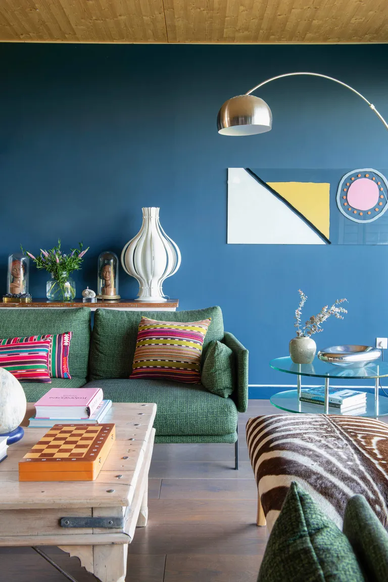 Blue living room with green sofa