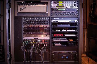 Racks holding Peter’s Fender Bassman amp, switchers, and effects