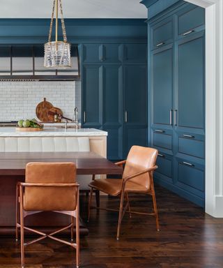 blue kitchen with tan leather chairs