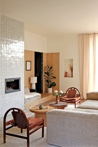 a cozy living room with a tiled fire place
