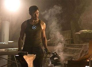 Robert Downey Jr., who plays Tony Stark, works on his metal suit in an official photograph from