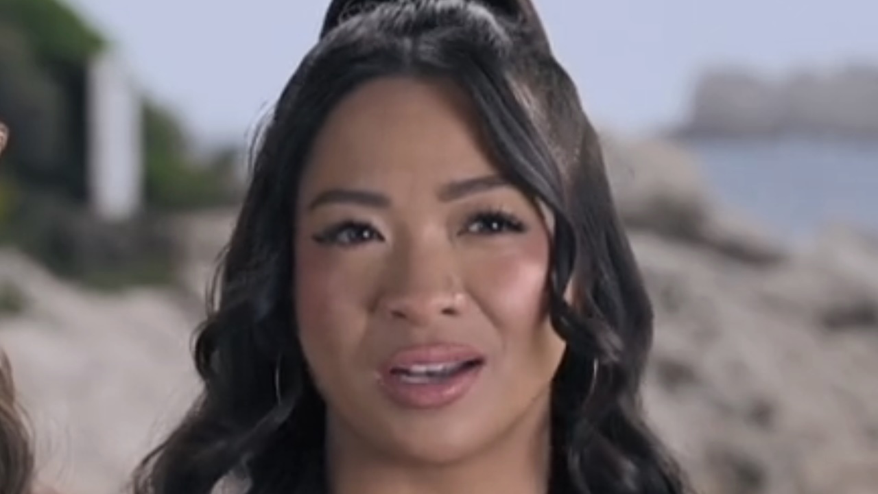 Rubina talking with a beach in the background