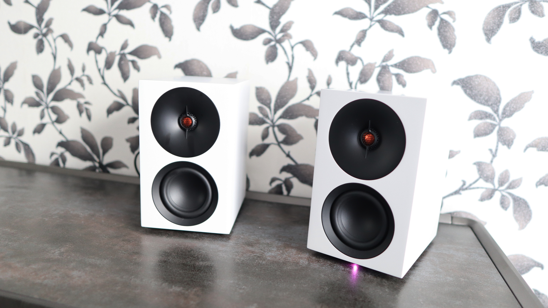 Cambridge Audio's L/R S speakers on a desk. The speakers are white with black tweeters.