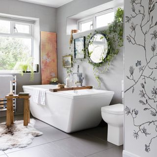 grey bathroom with bath and wall mural