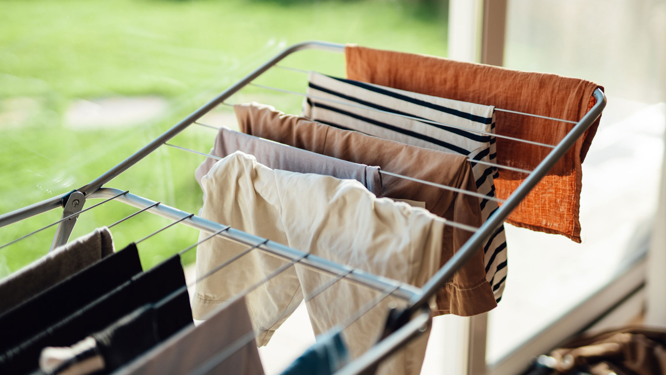 A close-up picture of a drying rack with wet clothes