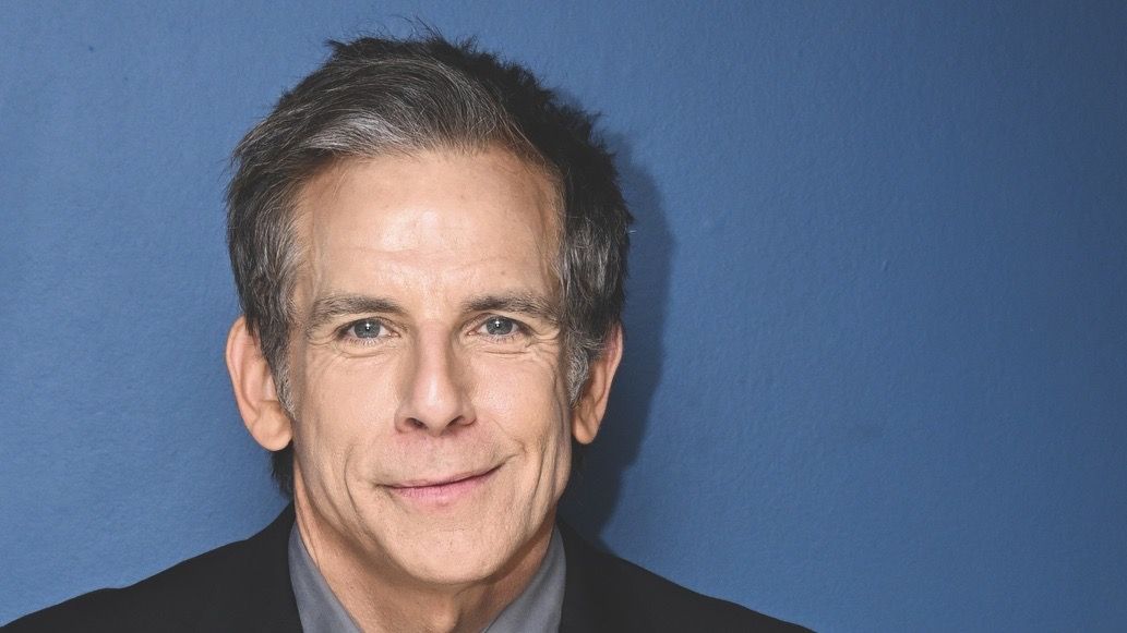 Severance director Ben Stiller against a blue background.