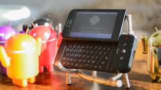 T-Mobile G1 phone with Android vinyl figurines