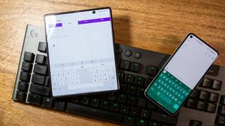Various keyboard apps for Android on two Android phones kept on a physical keyboard.