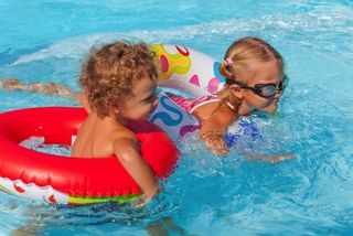 An image of a girl and a boy in a pool