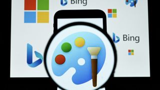 The logo of Paint is displayed on a mobile phone screen in front of a computer screen displaying the logos of Microsoft, Paint and Bing.