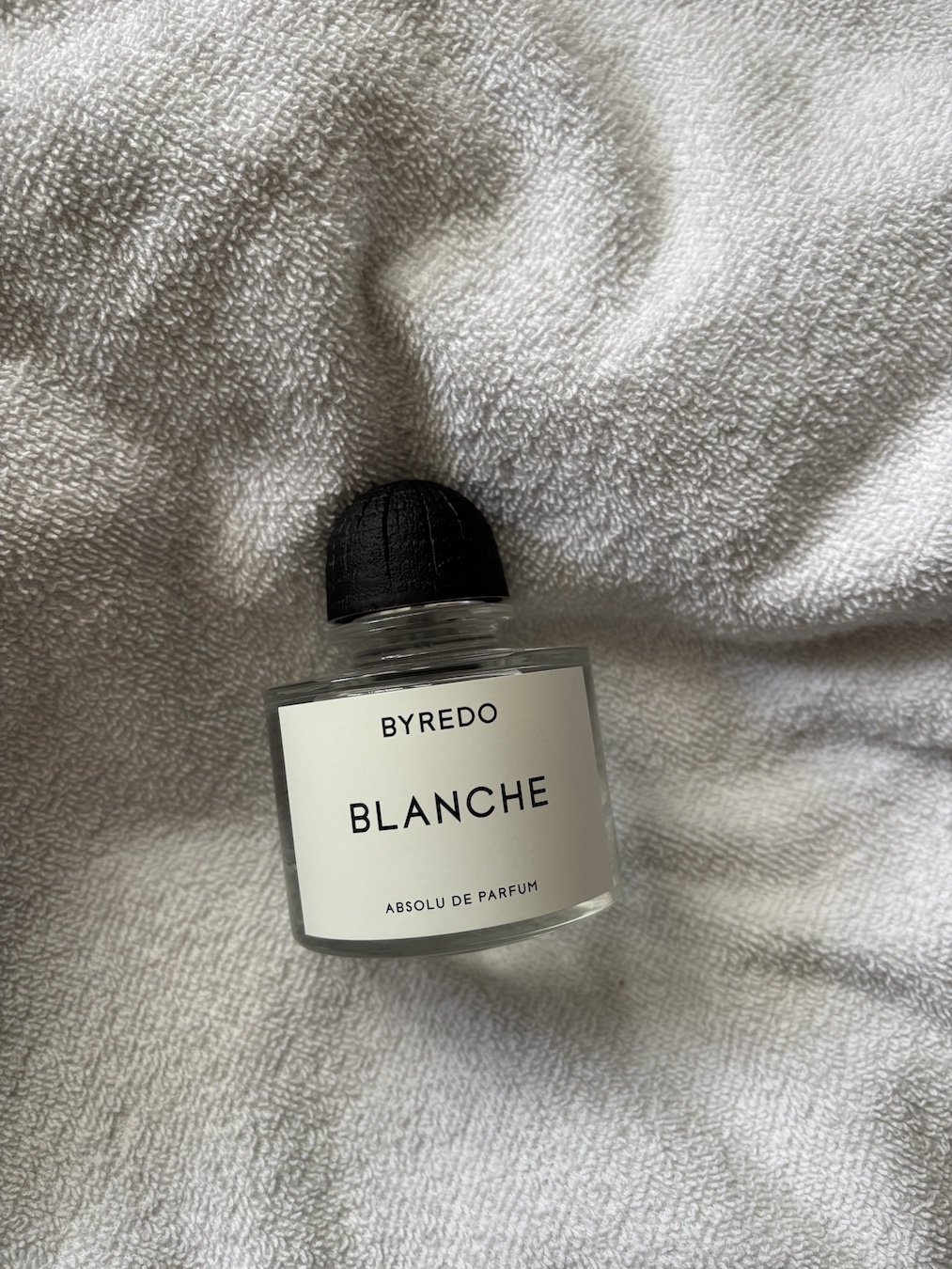 Bottle of Byredo Blanche Absolu on clean white towel