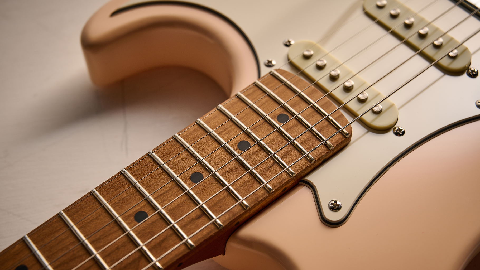 The roasted maple neck of a Cort G200SE electric guitar