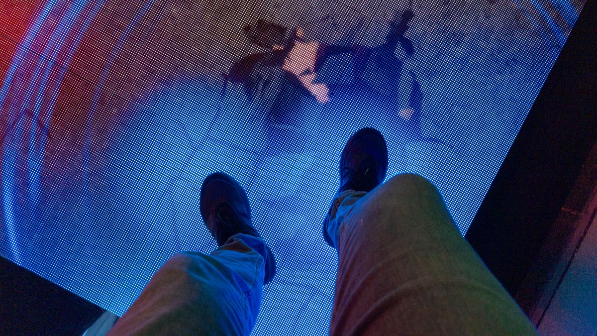 Stepping on a digital floor display at Google's San Diego Comic-Con Rewards Lab