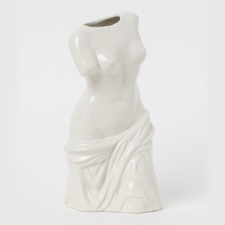 A stone vase shaped like a female torso in Renaissance style