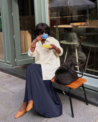 French woman in navy skirt and shirt