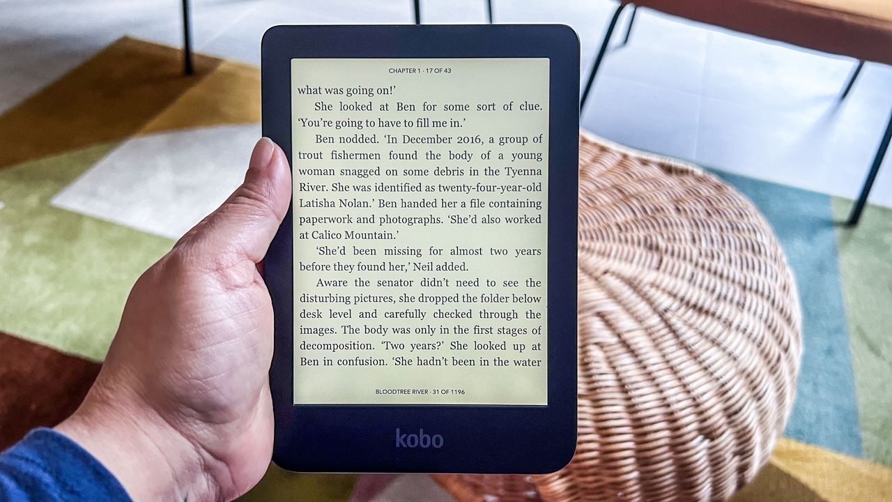 A hand holding the Kobo Clara BW ereader