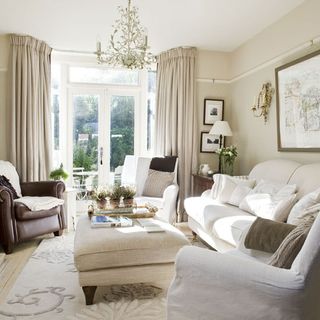 living room with cream sofa and leather armchair