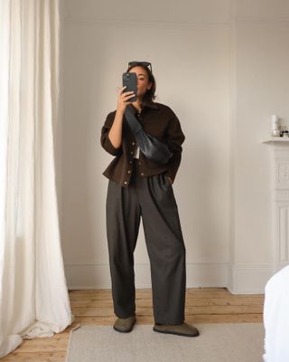 Influencer wears barrel leg trousers.