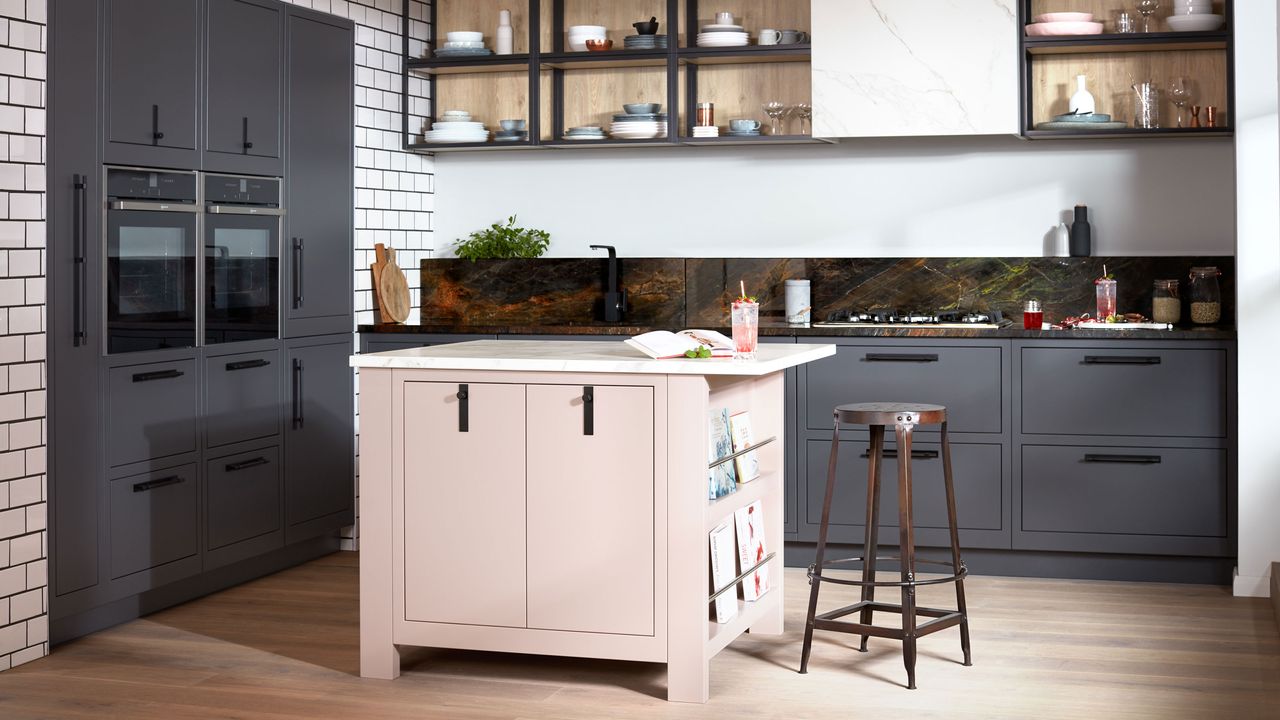 Blush pink kitchen island with book rack and bar stool